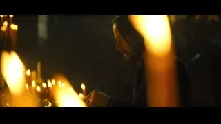 man with beard by many lit candles — John Wick: Chapter 4
