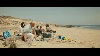bald man on a sandy beach — Furious Seven