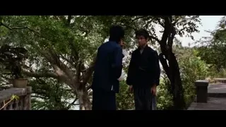 Two men talking on wooden bridge — Bruce Lee: Enter The Dragon