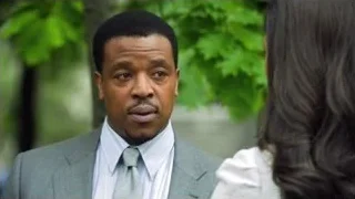 African-American man speaking to woman in park — Suits