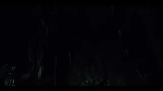 Person with flashlight in dark forest — Jurassic World