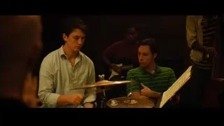 Two young men playing drums in dim room — Whiplash