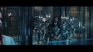 men in futuristic suits at metal gate — Doctor Strange 2