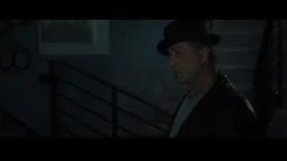 Man in black hat on staircase in dark room — Creed 2