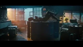 man lying on blue barrels in room — Deadpool 2