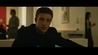 Young man in suit sitting at table — The Social Network