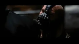 Person wearing skull-like mask in dim room — Batman: The Dark Knight Rises