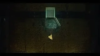 person standing in dark brick room — The Bear
