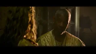 man and woman conversing in dimly lit room — Gladiator 2