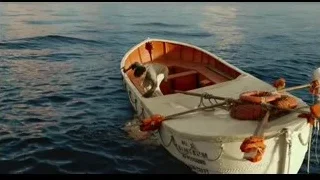 man working on small boat in ocean — Life of Pi