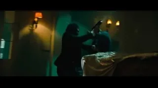 man and woman with gun in old room — John Wick: Chapter 4
