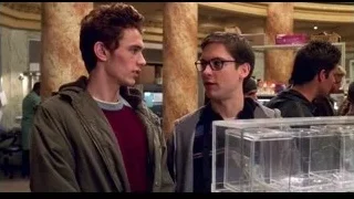 two men looking at display case — Spider Man