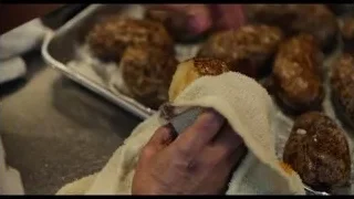 hands wiping bread rolls in kitchen — The Bear