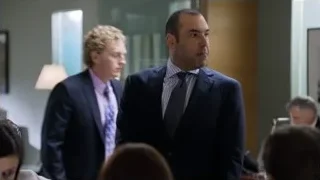Man in suit speaking to group — Suits