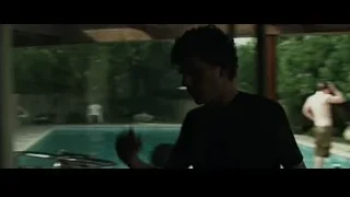 young man standing looking out window — The Social Network