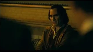 man sitting on bench in dimly lit room — Joker