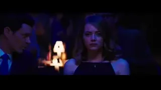 woman standing in dimly lit room — La La Land