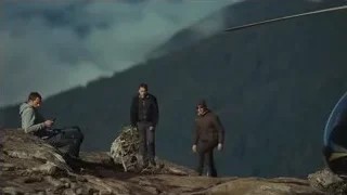 three men on rocky mountain cliff — Succession