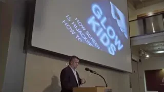 man in suit giving presentation at podium — Screened Out