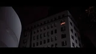 modern building lit with orange lights at night — American Psycho