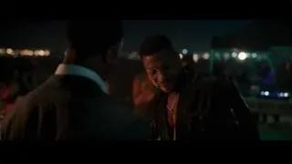 two men conversing at night city event — Creed 3