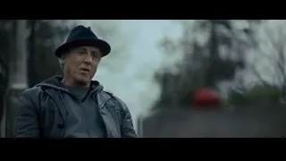 Elderly man in park with red car — Creed 2