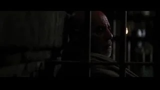 man behind bars in dark room — Batman: The Dark Knight Rises