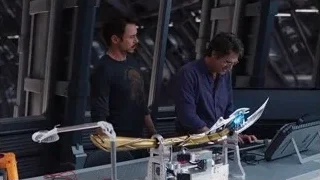 men working on robotic arm in factory — The Avengers