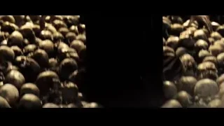 Man standing in field of skulls with windmill — Superman: Man of Steel