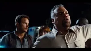 Two men talking intently near car — Jurassic World