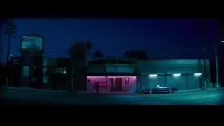 Woman sitting in car at sunset — La La Land