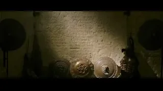 stone wall with text and circular plates — Gladiator 2