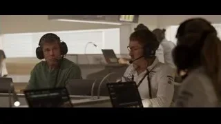 People in control room looking at screens — F1