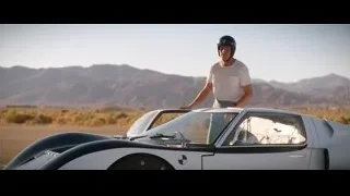 Young man by futuristic car in desert — Ford v Ferrari
