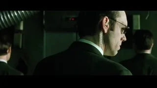 man's face wearing sunglasses in dim room — The Matrix
