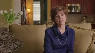 woman in blue sweater sitting on couch — Screened Out