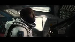 man in space suit holding gun in control room — Interstellar