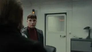 Woman and man conversing in dimly lit room — Blade Runner 2049