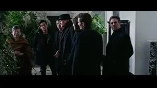men in formal attire in hallway — Now You See Me 2