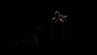 man and woman dancing in dimly lit room — La La Land