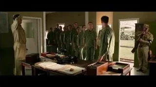 Military men gathered around desk, one presenting — Hacksaw Ridge