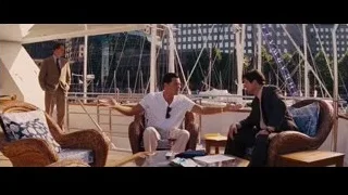 three men conversing on balcony overlooking marina — The Wolf Of Wall Street