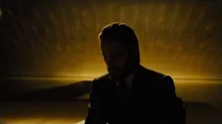 man sitting in dimly lit empty room — Blade Runner 2049