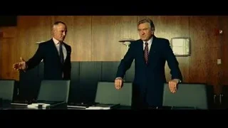 two men in suits talking in meeting room — Limitless