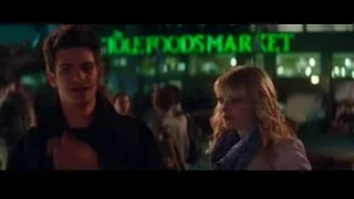 Man and woman near neon store sign — The Amazing Spider Man 2