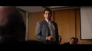 man in suit giving presentation to group — Ford v Ferrari