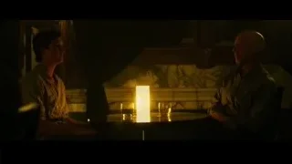 two men at table with whiskey and candle — Whiplash