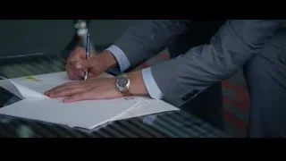 person in grey suit writing with pen — The Big Short