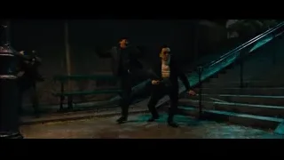 man in suit walking up stairs at night — John Wick: Chapter 4