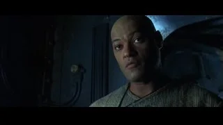 bald man in gray sweater looking at camera — The Matrix